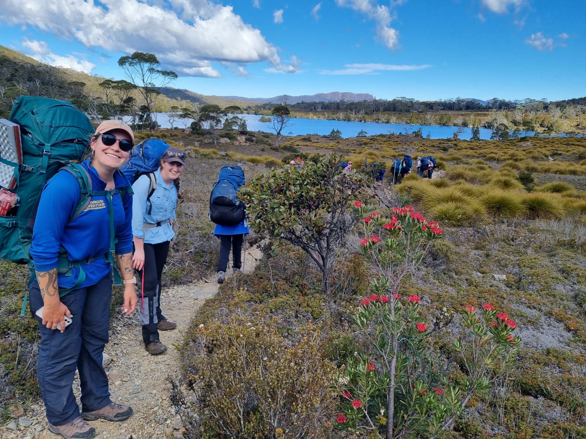 Southbound outdoor educators walking a highland track with a student group