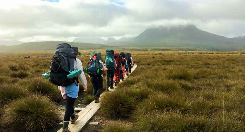 Students hiking a boardwalk trail on a Bronze Adventurous Journey